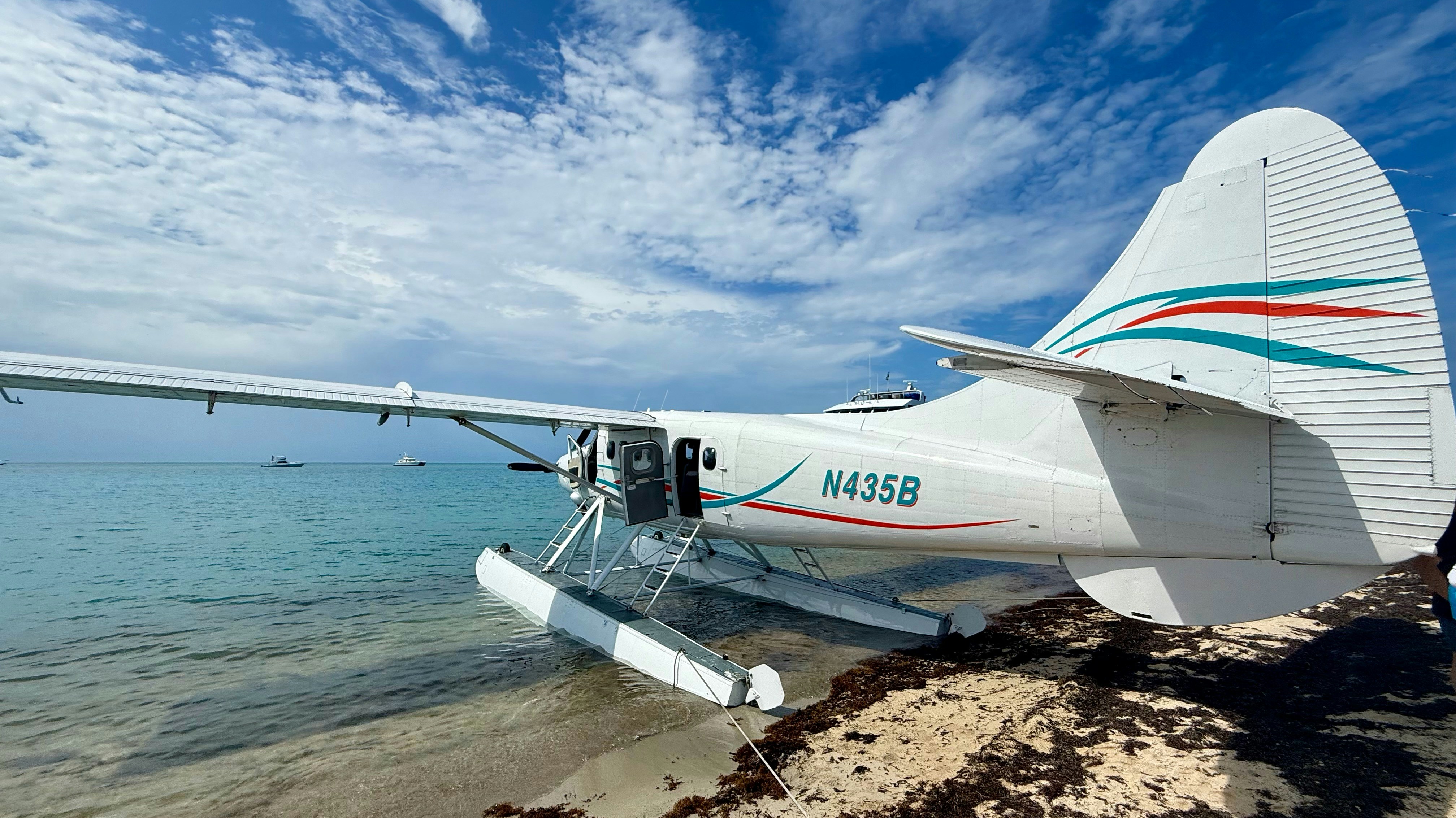 Seaplane resting on a sandy beach near the ocean