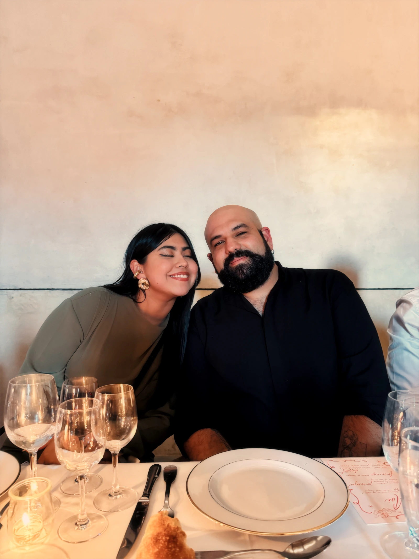Couple smiling together at a restaurant table during a relaxed date