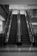 Two escalators ascend in a modern building