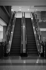 Two escalators ascend in a modern building
