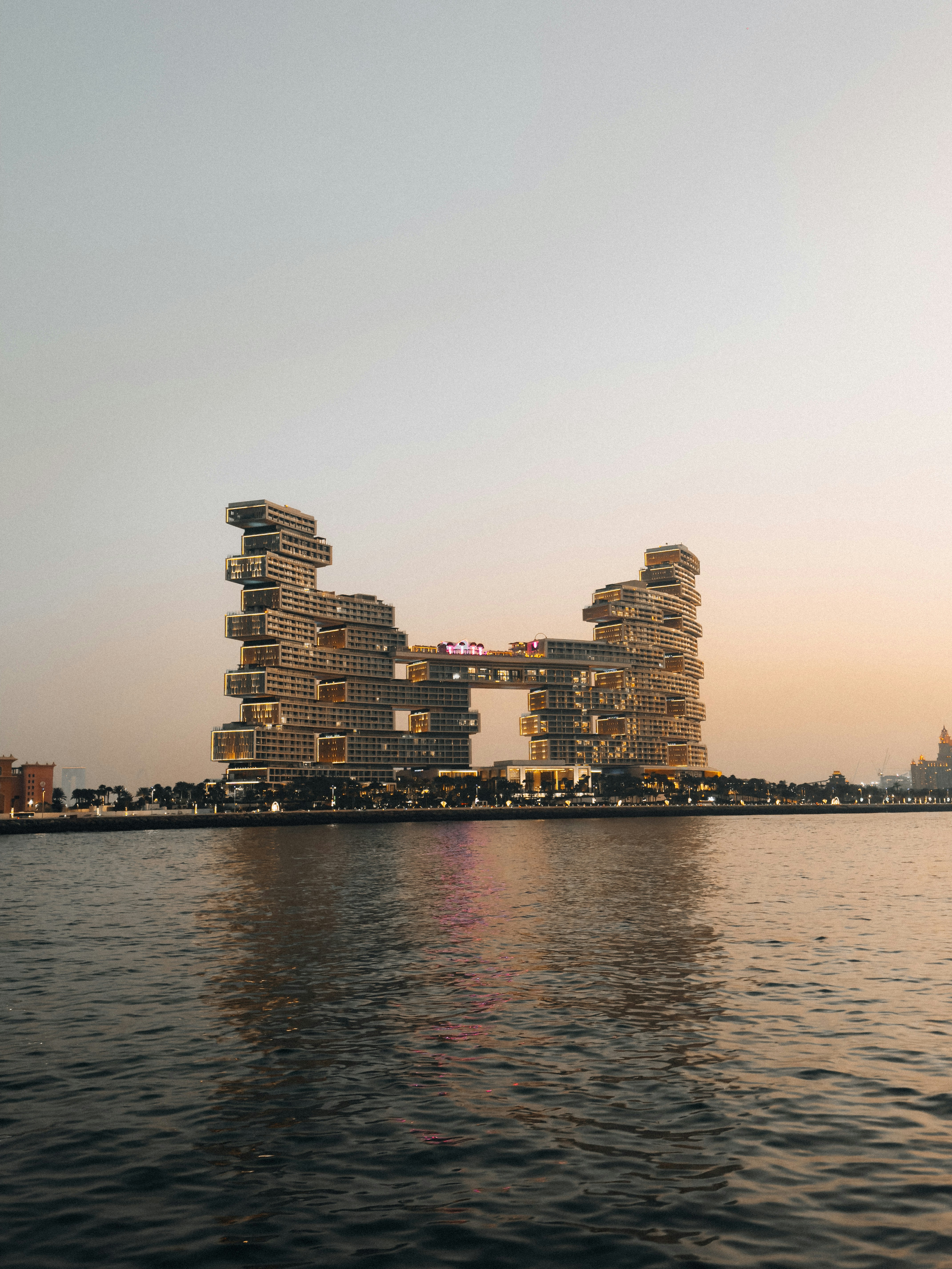 Modern hotel building on the water at sunset
