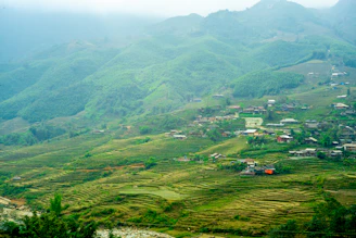 Green terraced hills with small village nestled within.