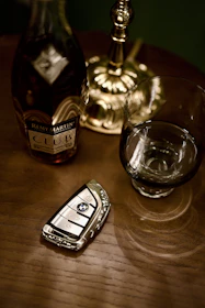 Bottle of remy martin, car key, and glass