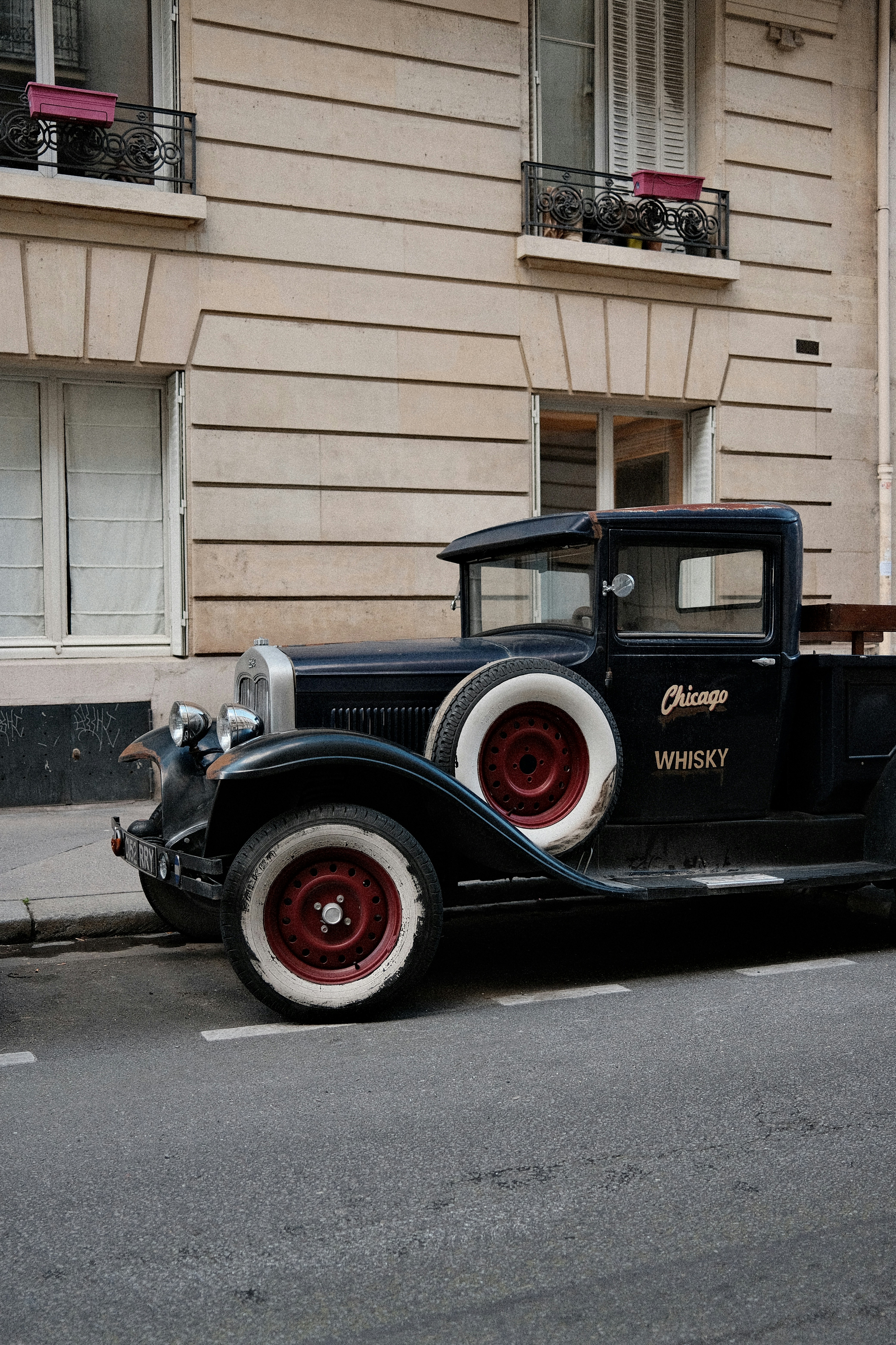 Caminhão preto vintage estacionado numa rua da cidade.