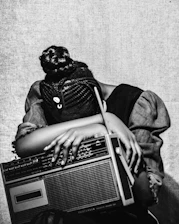 Woman resting head on vintage radio