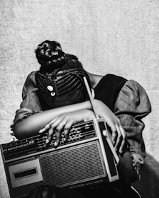 Woman resting head on vintage radio