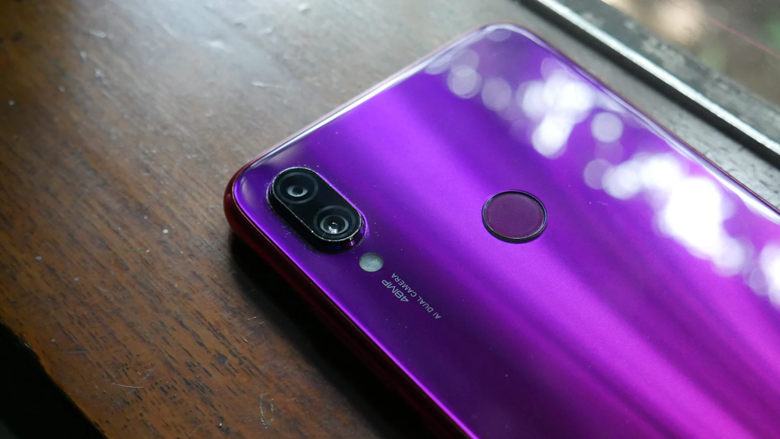Purple smartphone with a fingerprint sensor visible on the back