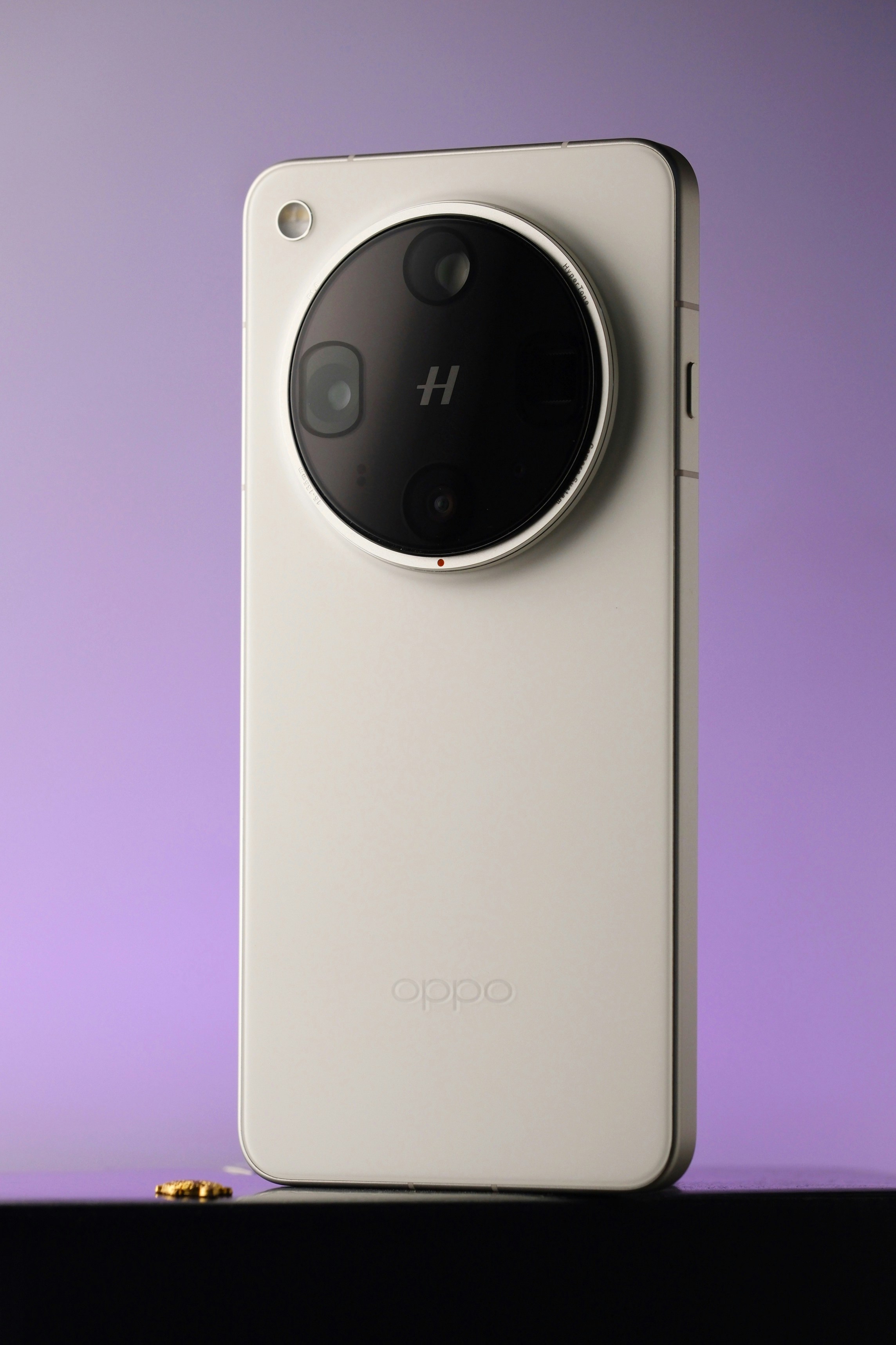 A white smartphone with a large circular camera module. photo – Free ...
