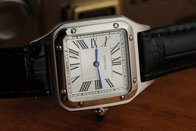 Luxury silver square watch with a black leather strap