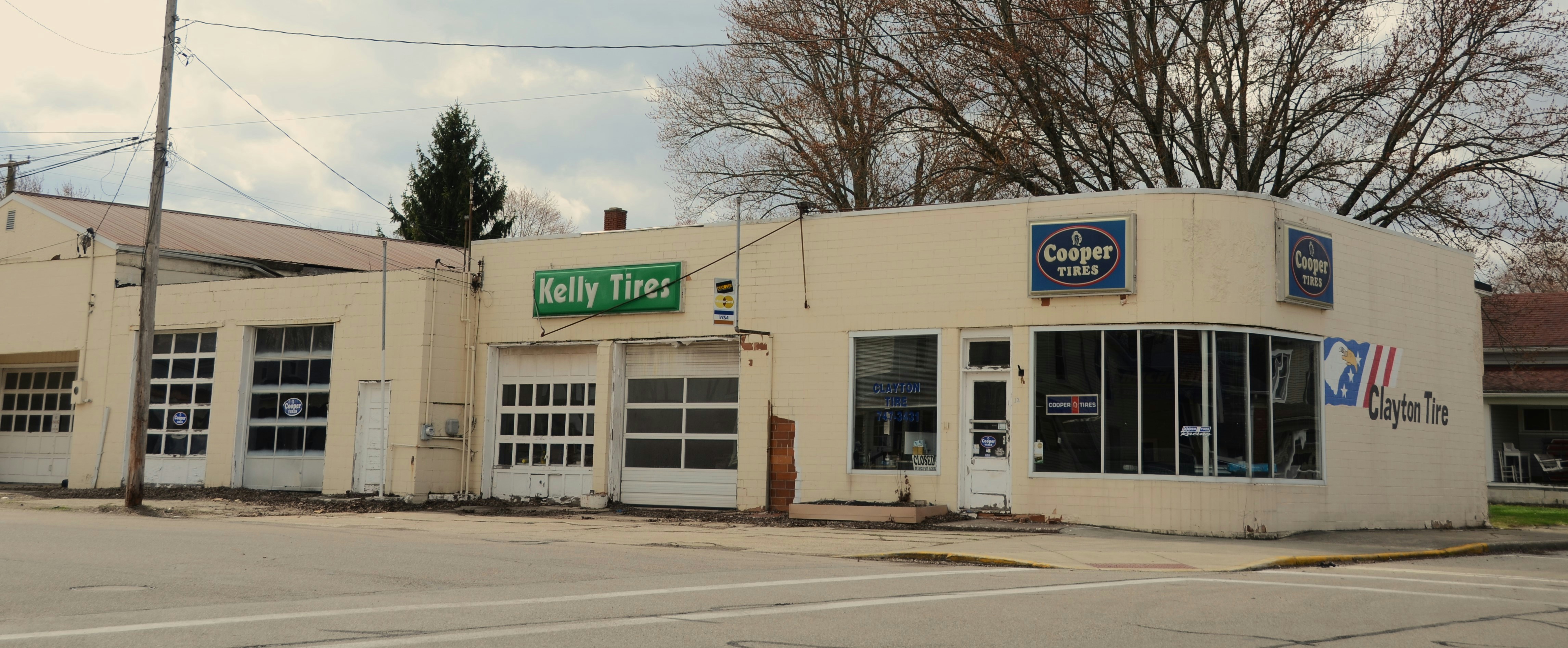 A beige building with garage doors and windows.
