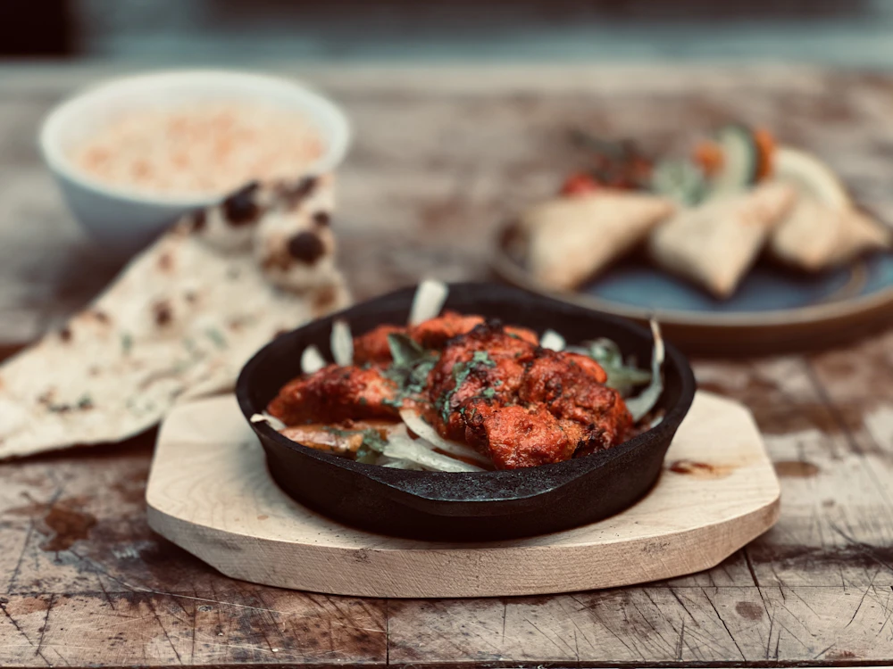 Illustrative Indian meal with tandoori chicken and breads