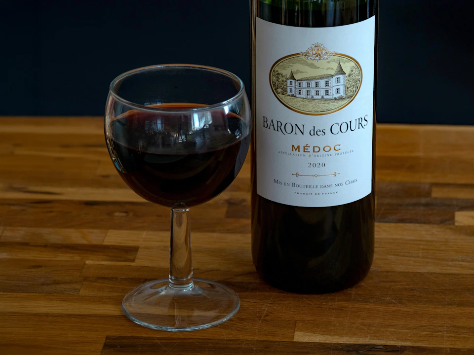 A glass of Bordeaux wine poured for tasting