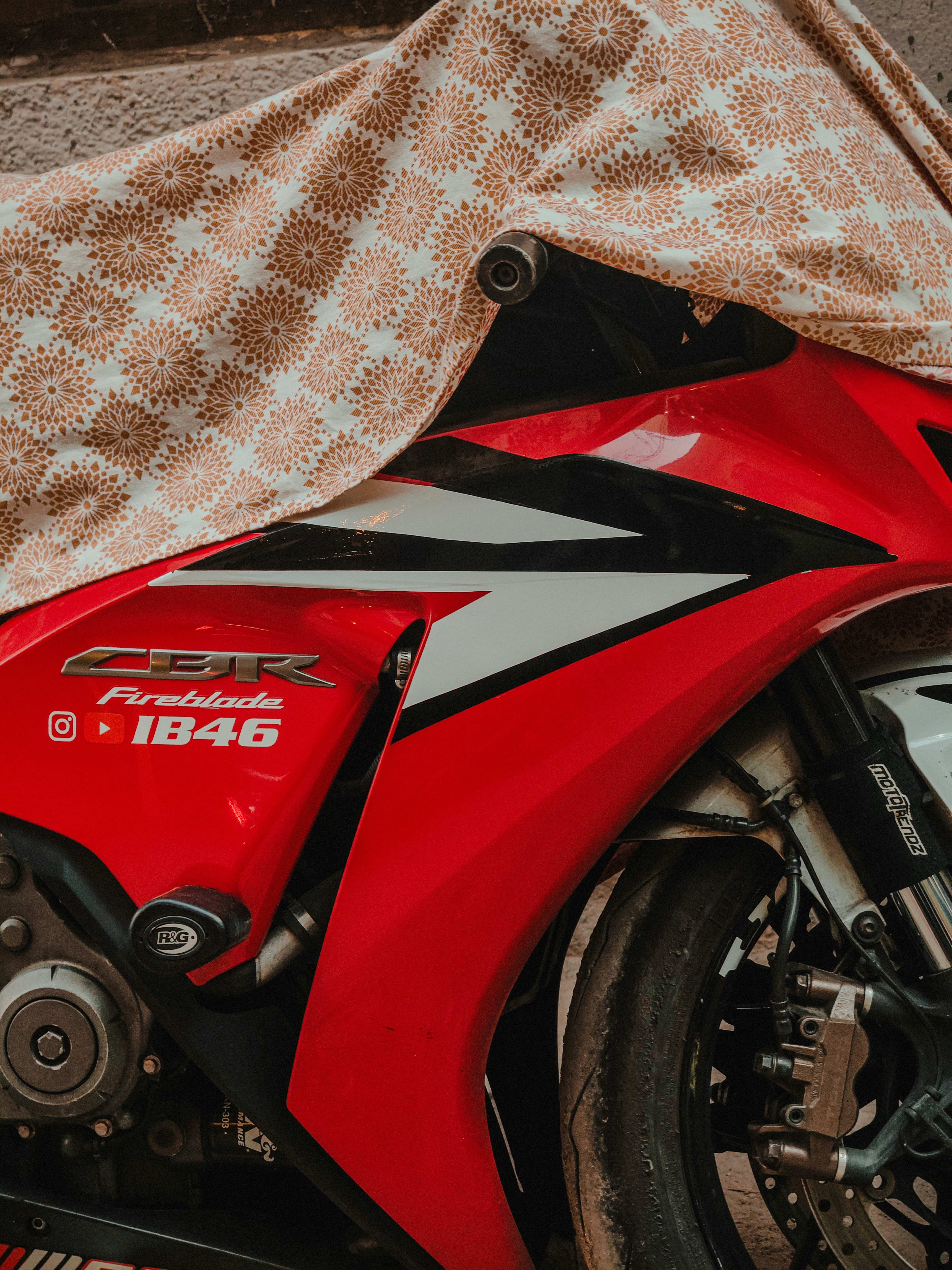 Red motorcycle covered with patterned cloth