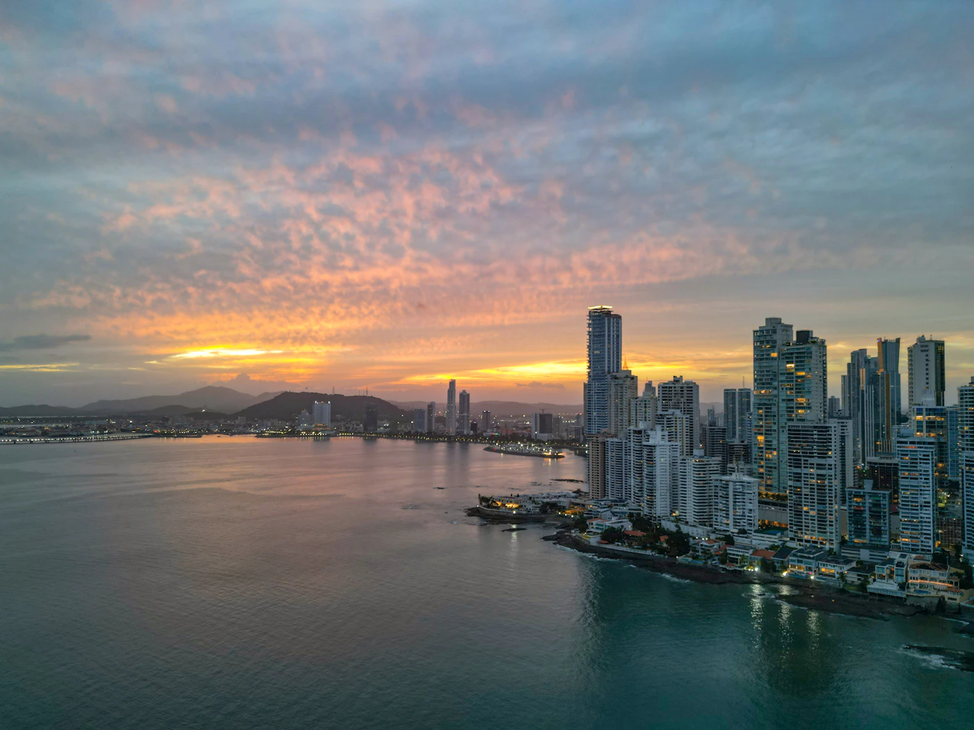 Panama City skyline at sunset over the ocean