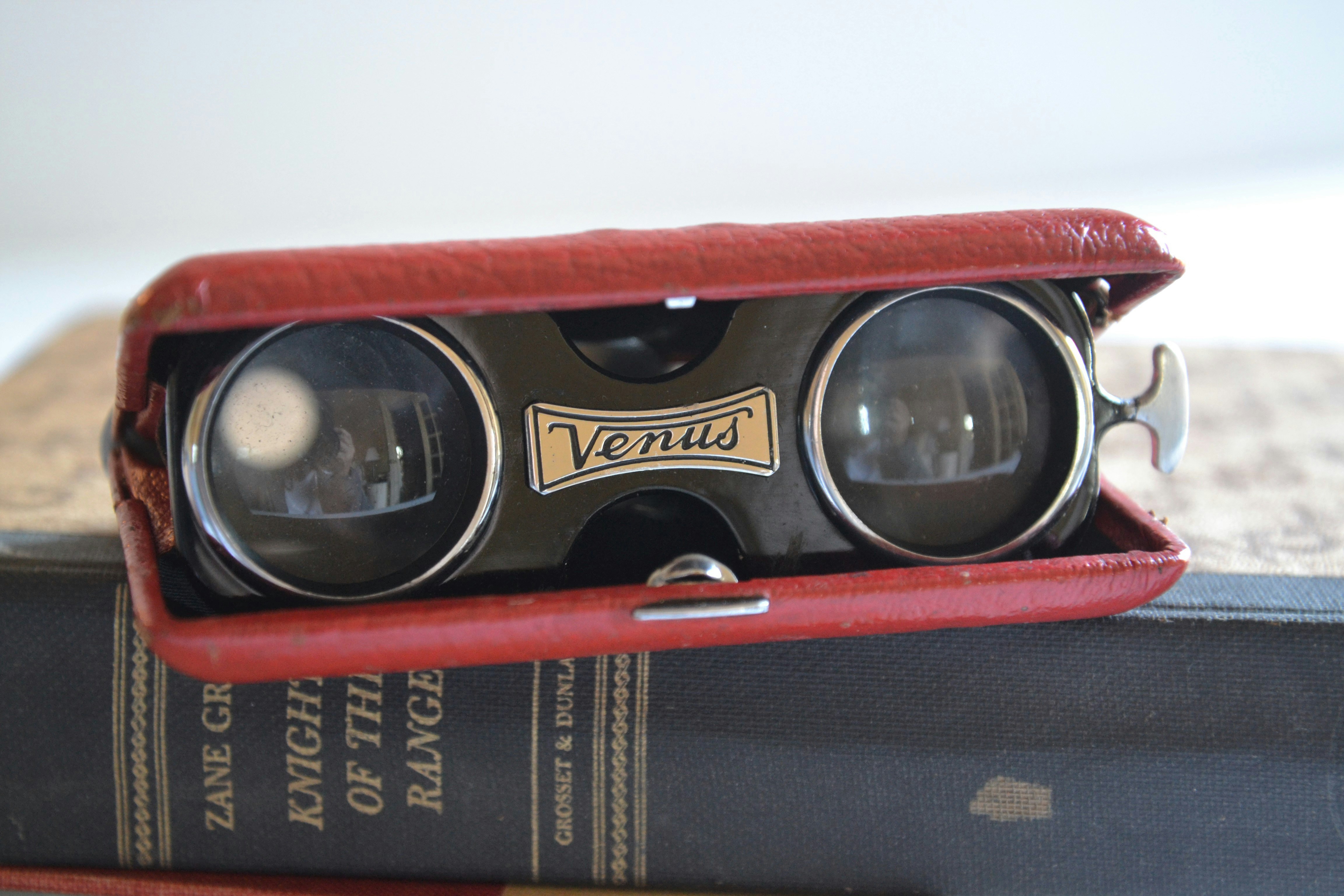 Vintage opera glasses in a red case