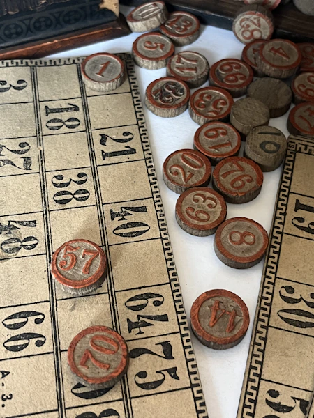 Vintage bingo cards and numbered wooden tokens.
