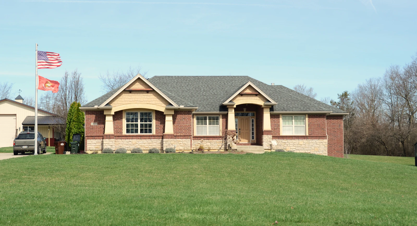 Modern home with a large uniform green lawn, free of brown patches