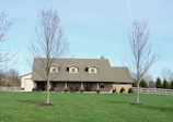 A large brick house with a dormer roof.