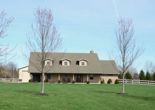 A large brick house with a dormer roof.