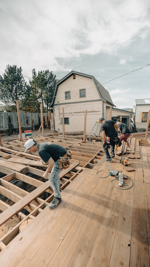 Crew building a wooden deck frame