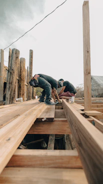 Two men working on a wooden deck construction