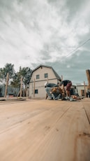 Construction workers building a wooden deck near a house.