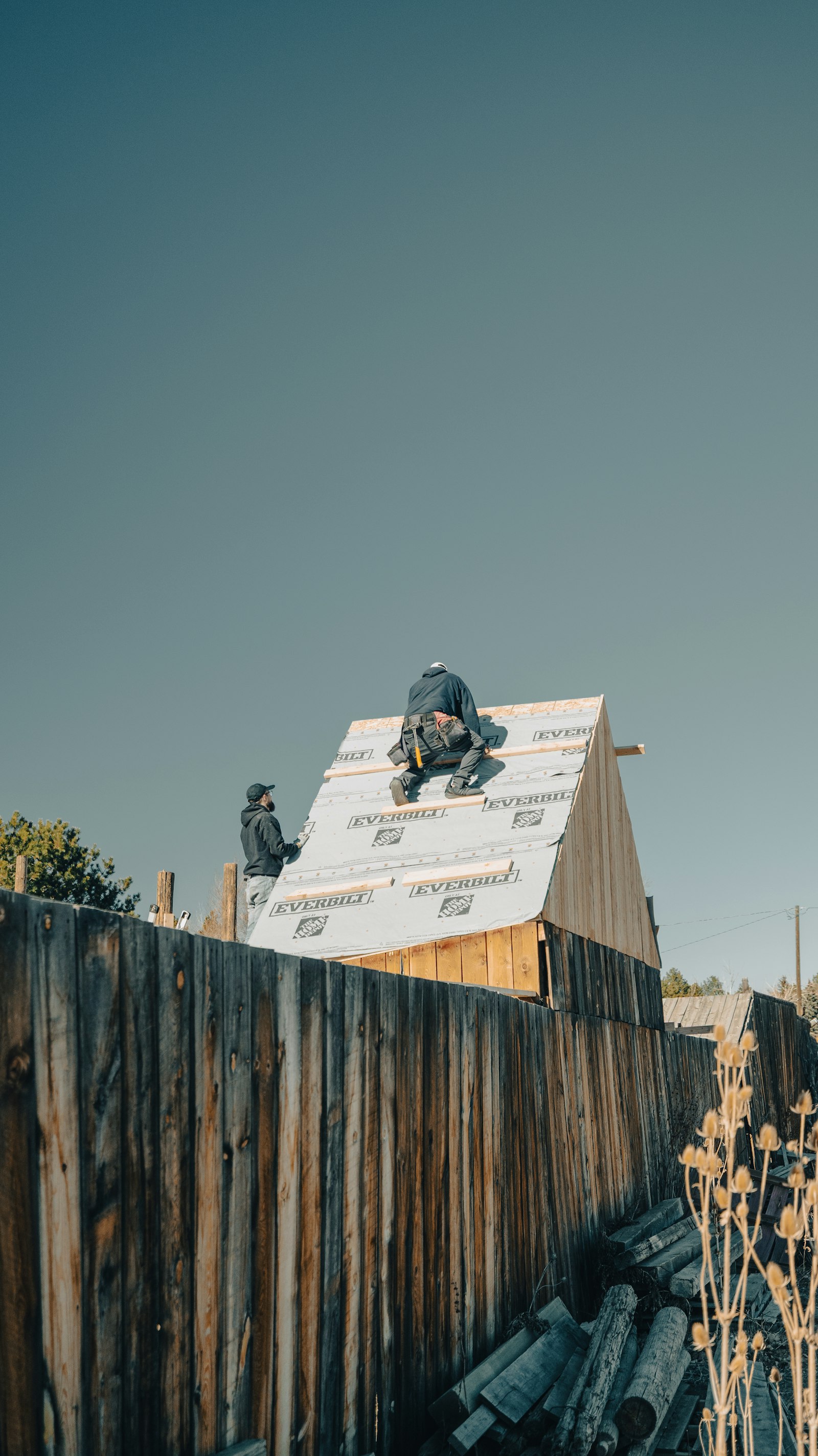Construction workers building a roof