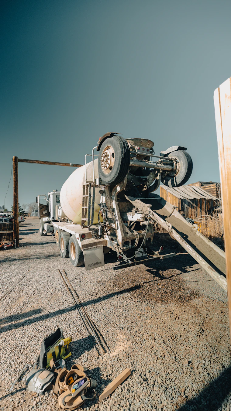 A concrete mixer truck on a commercial job site.