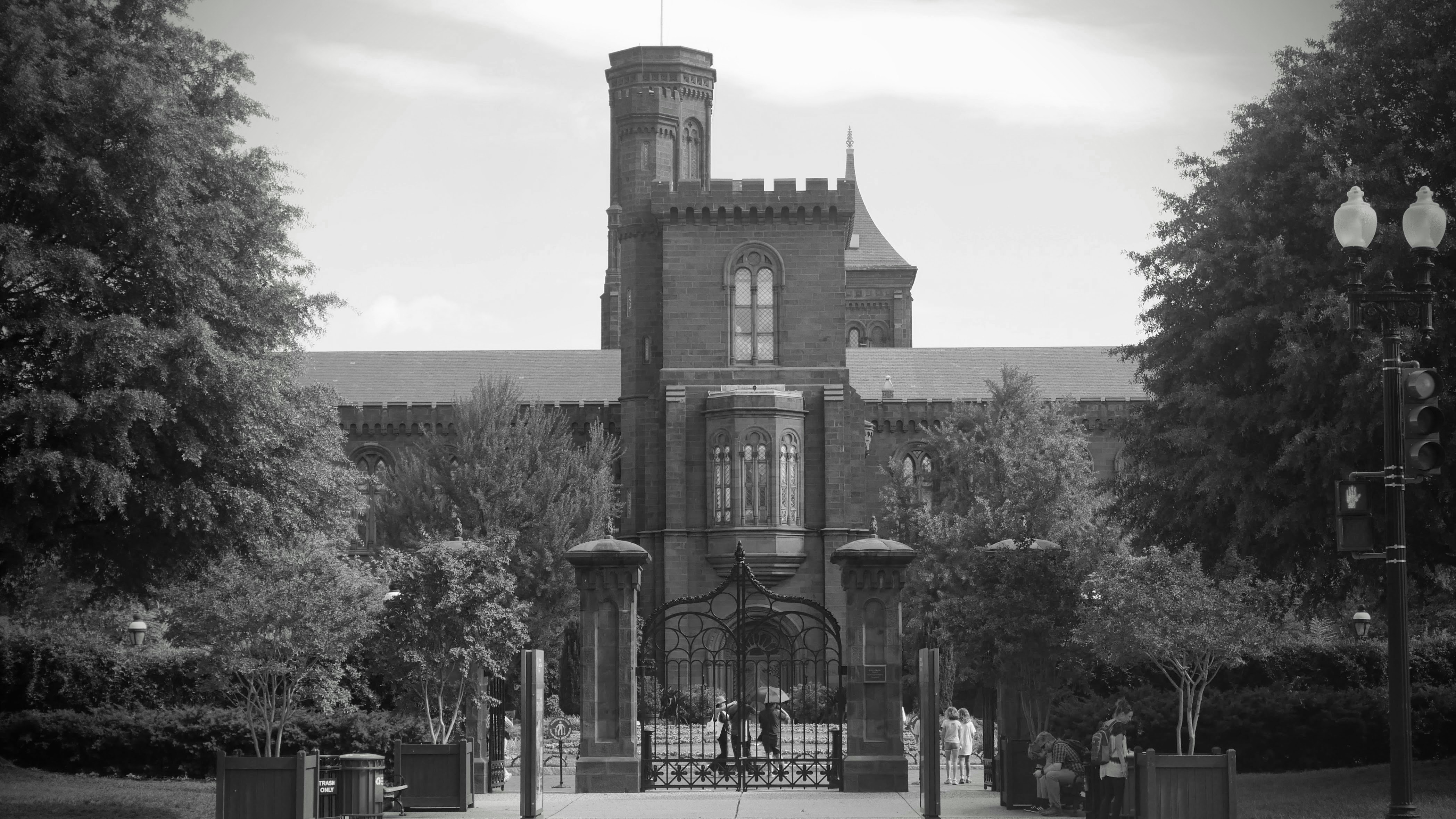 Historic brick building with trees and a pathway.