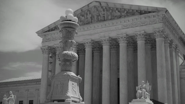 The supreme court building with a statue in the foreground