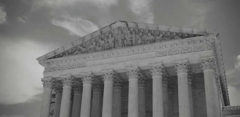 A grand stone court building with tall columns under a cloudy sky, a reminder that the Badlands tax case is headed to the Nevada Supreme Court