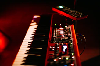 Red electronic keyboard with knobs and buttons