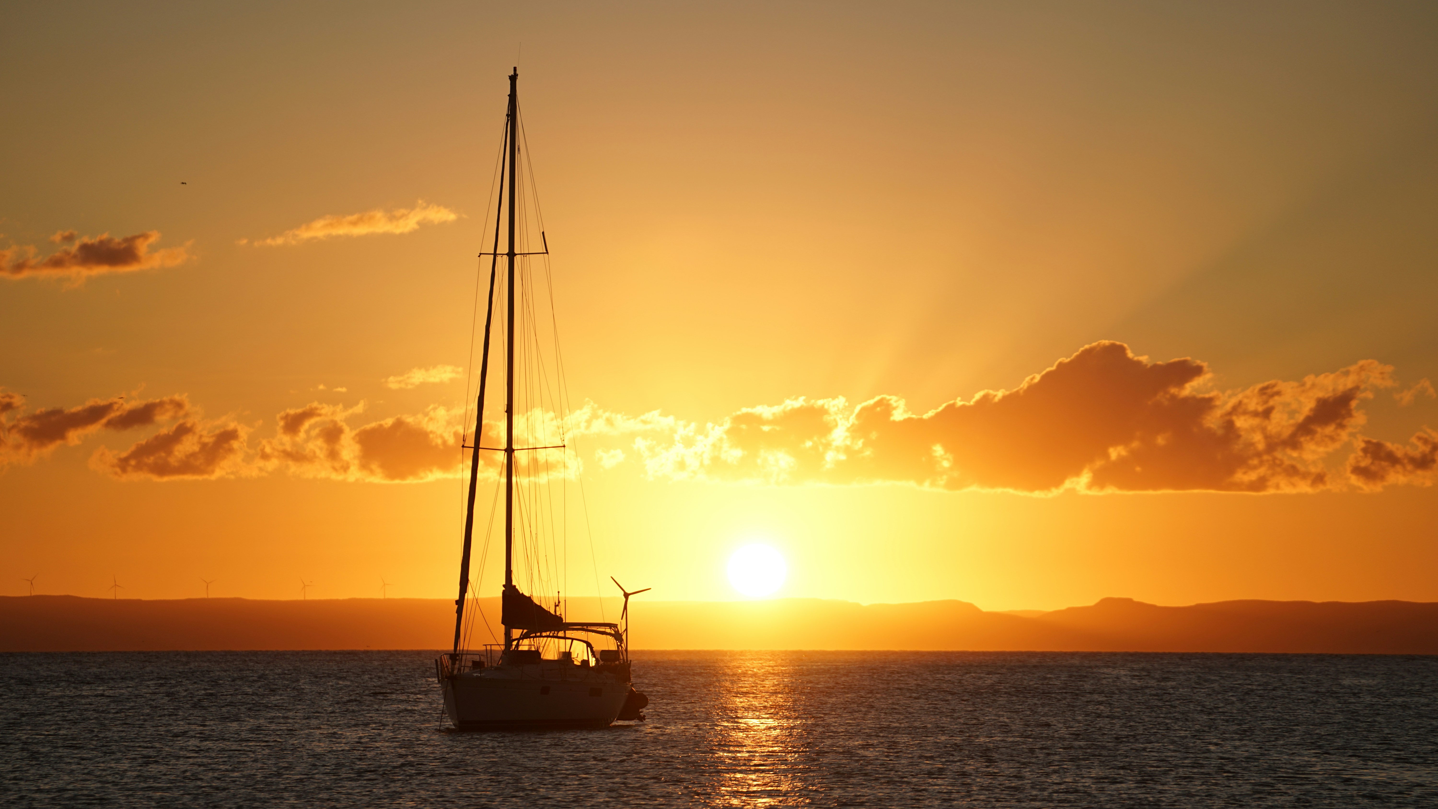 Sailboat on the ocean at sunset