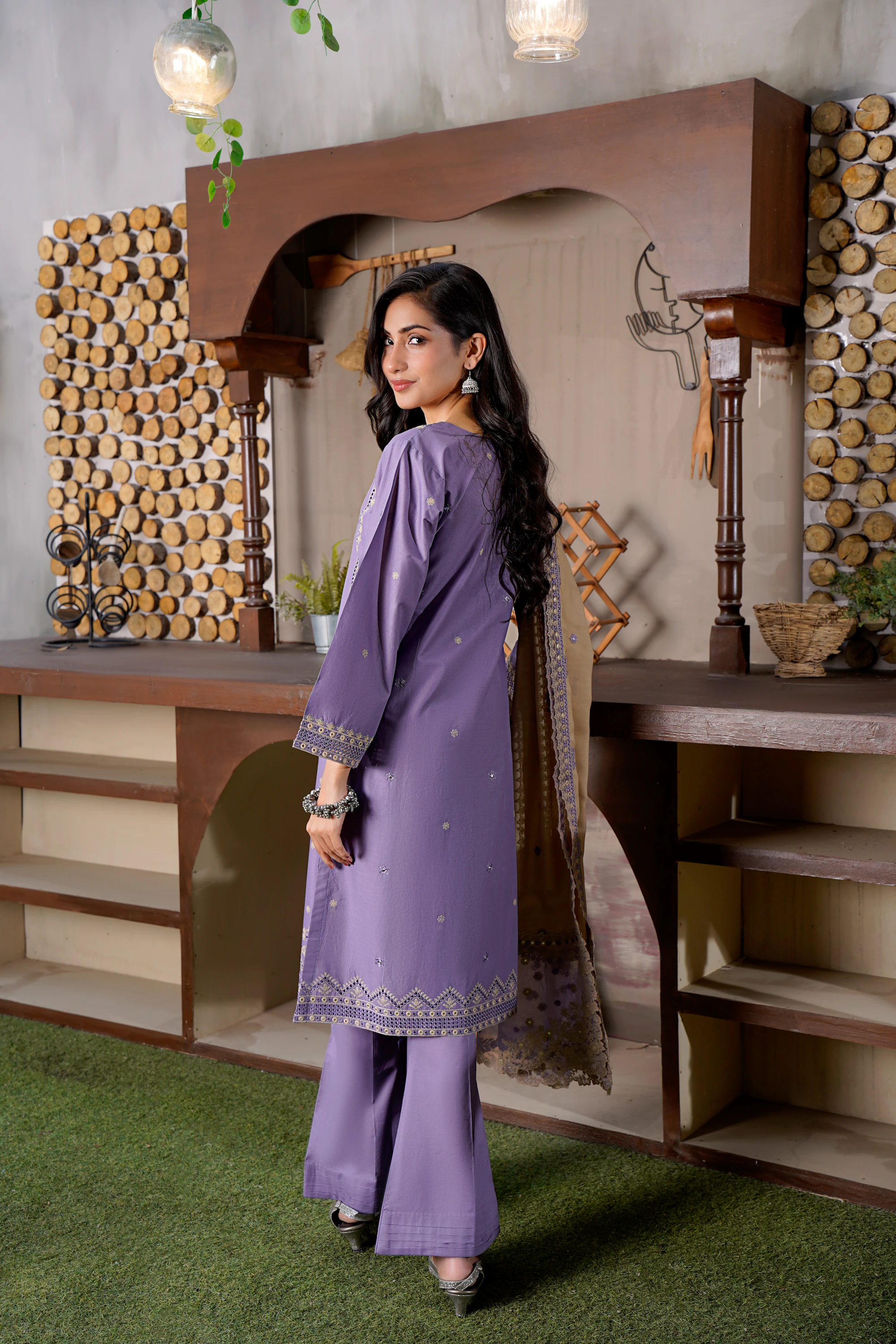 Pakistani woman in purple embroidered formal wear