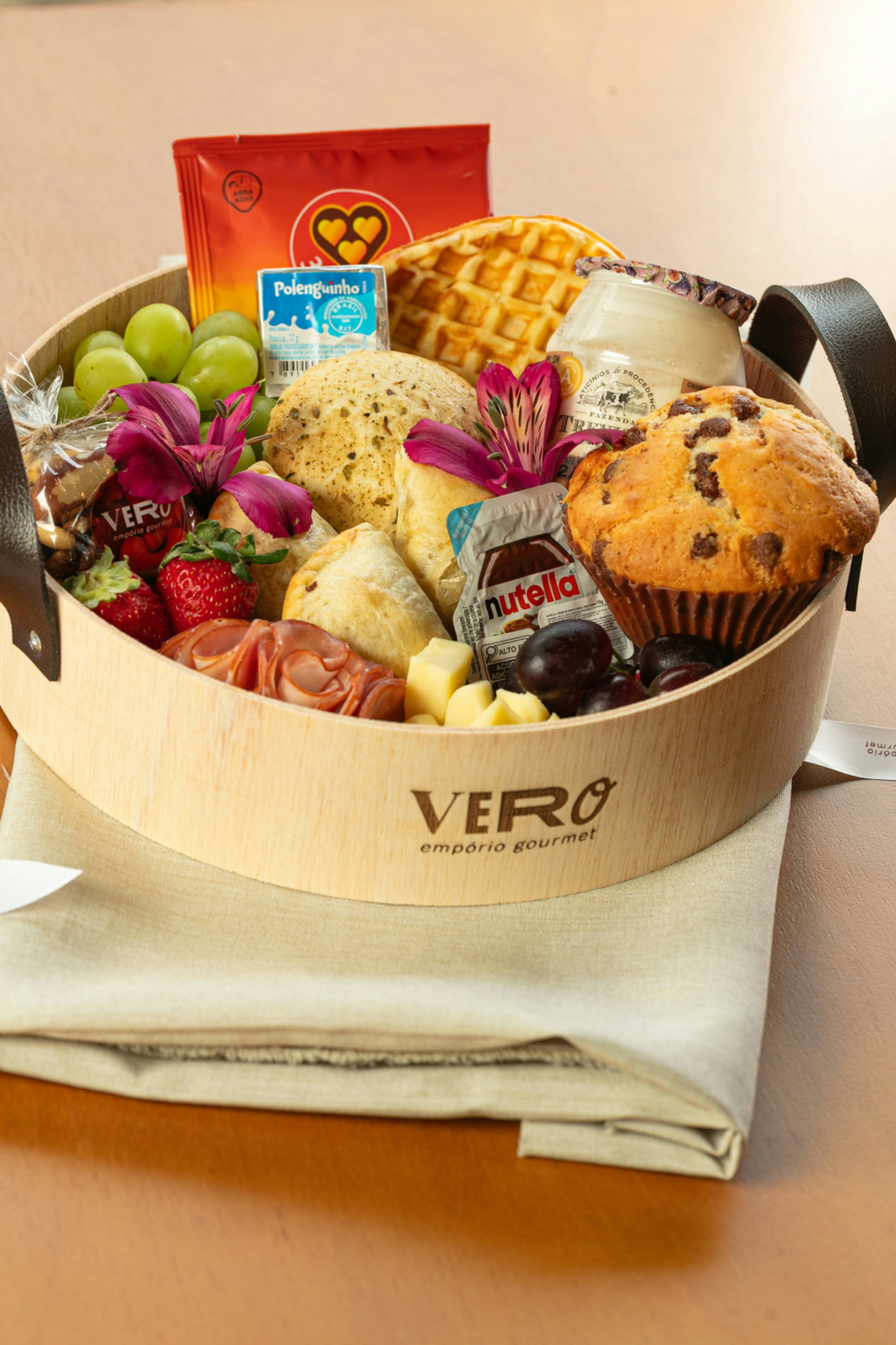 A wooden tray filled with breakfast items and fruit.