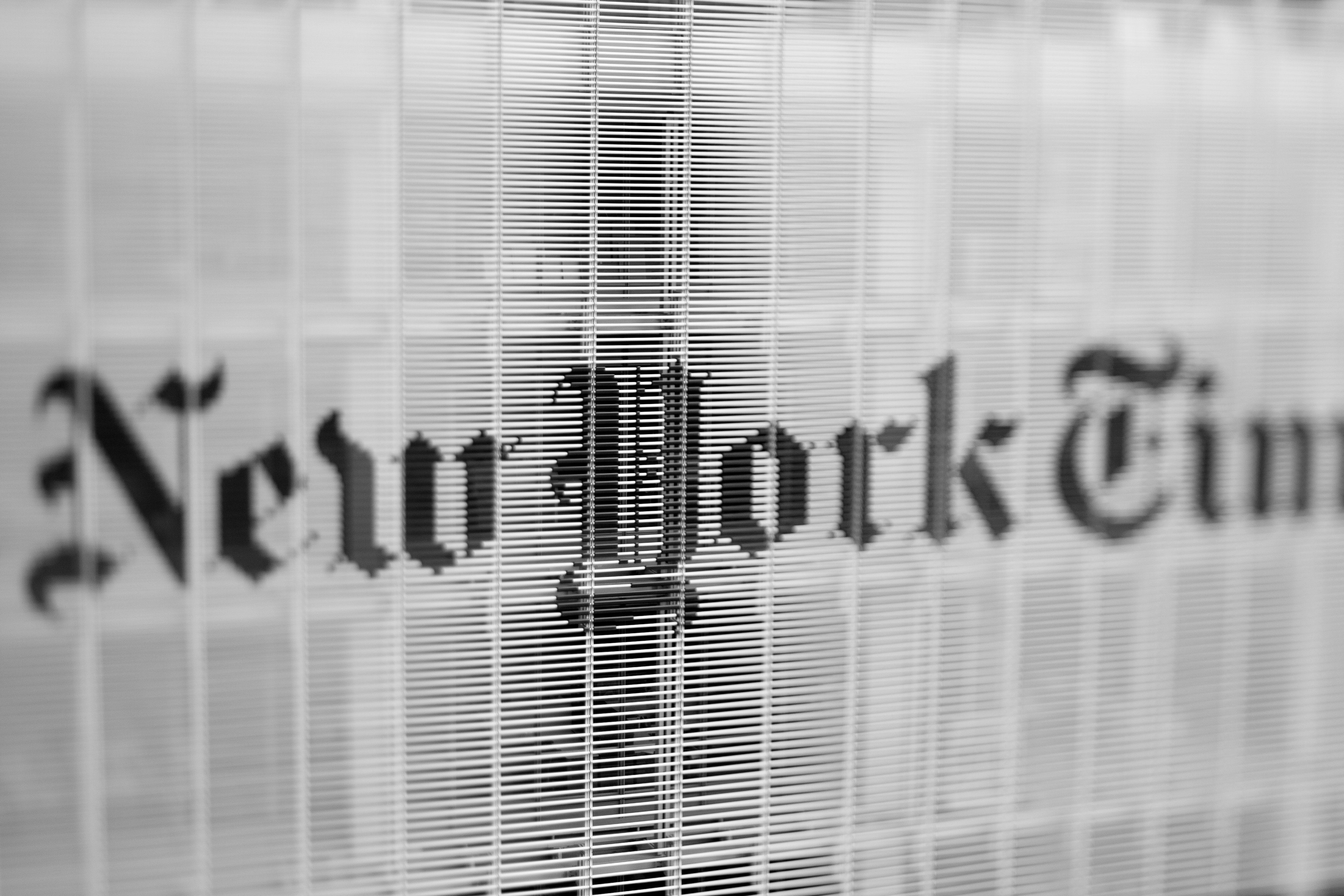 New york times logo on a textured background (Photo by Tim on Unsplash)