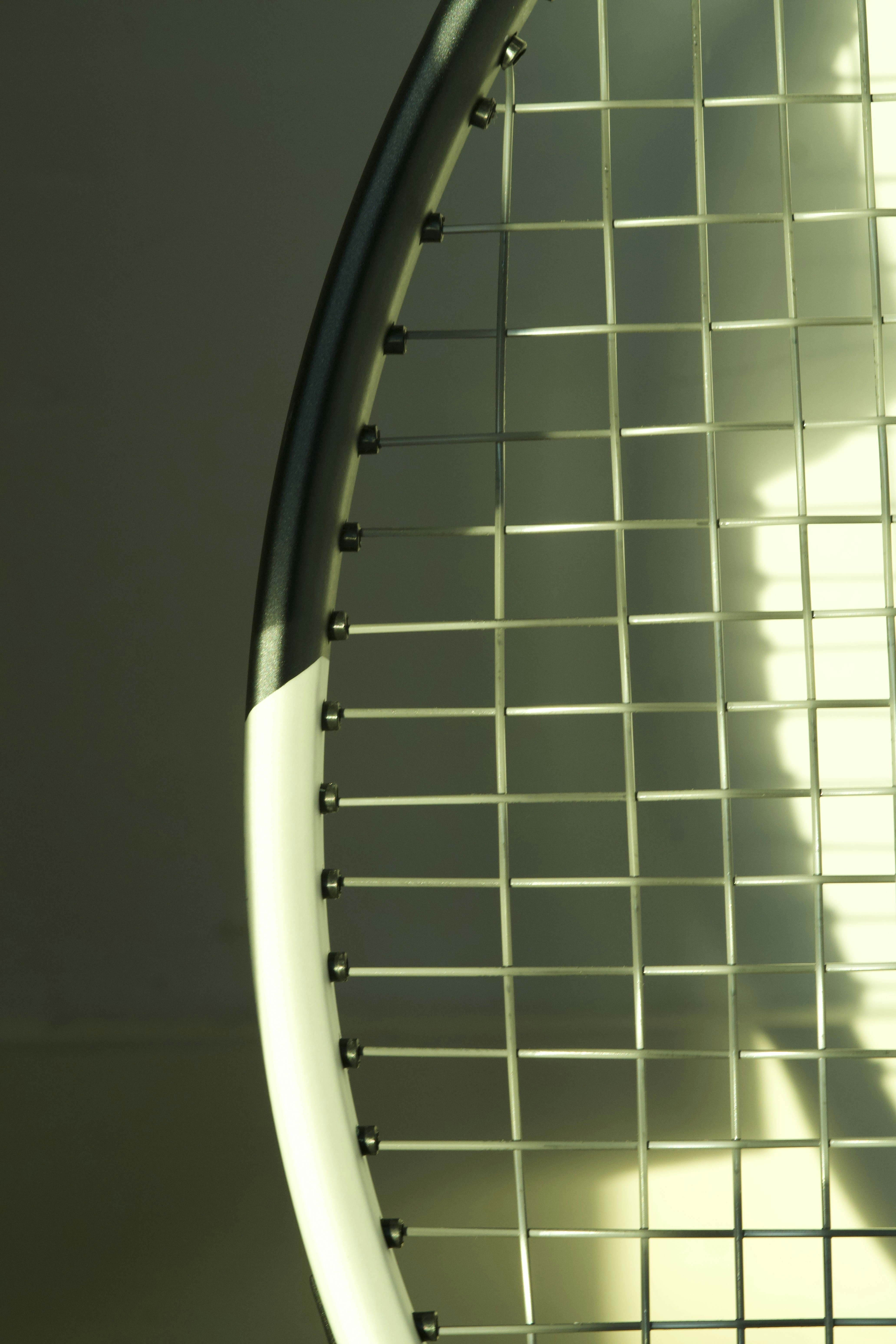 Close-up of a tennis racket strings and strings