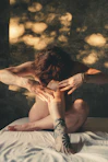 Woman in yoga pose on a white surface.