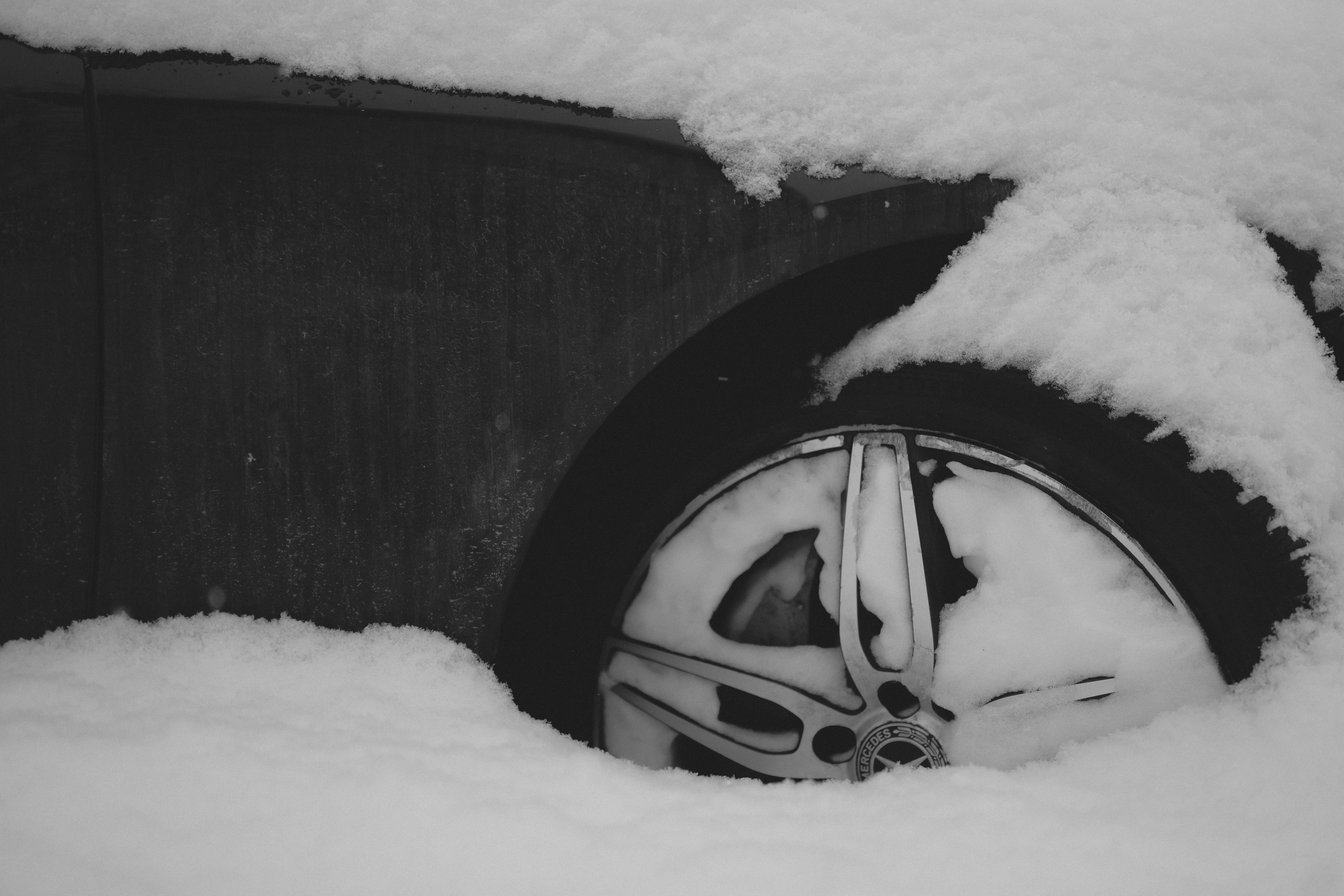 A car tire covered in thick snow