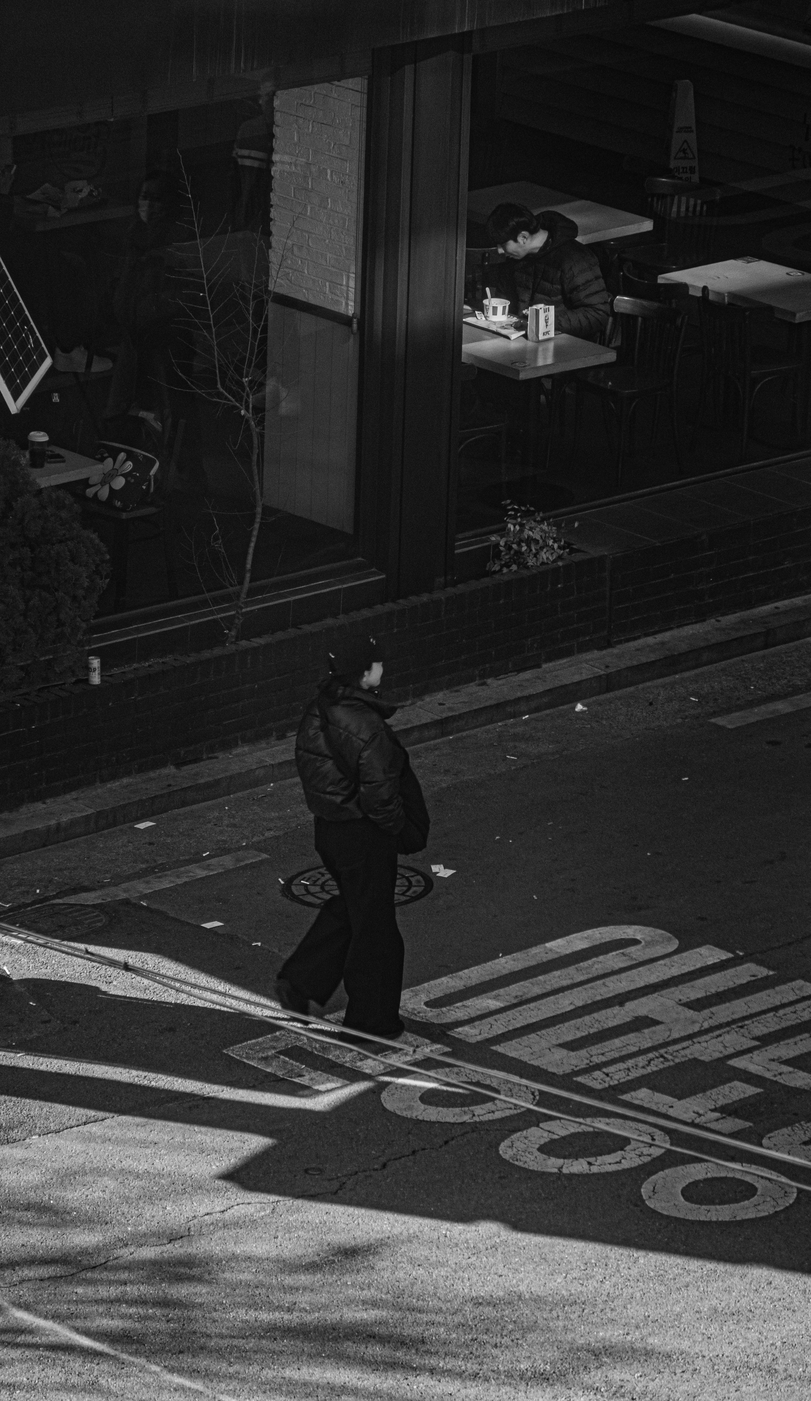 Person walking on street near cafe at night