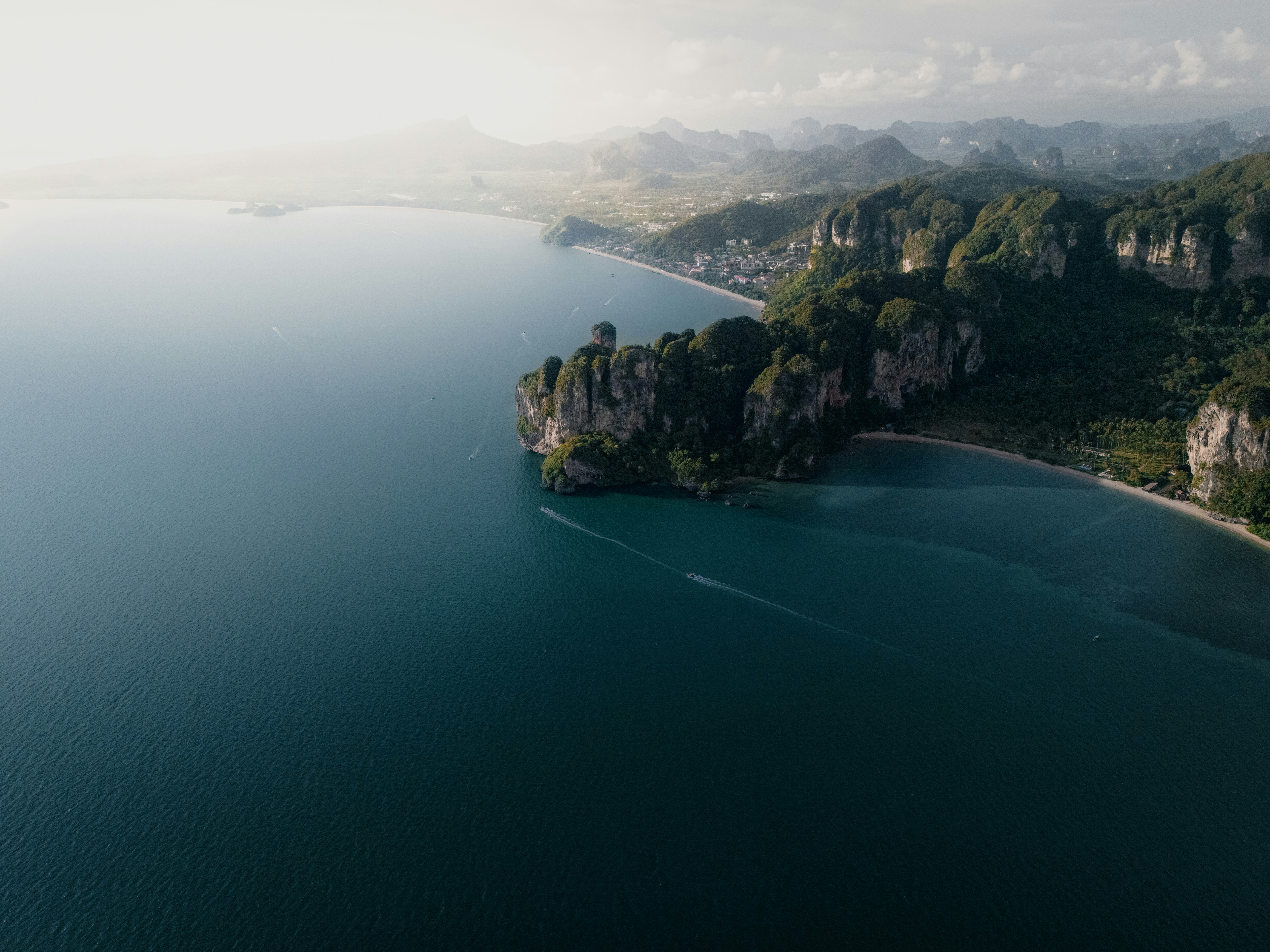 Coastal cliffs meeting the deep blue ocean water.