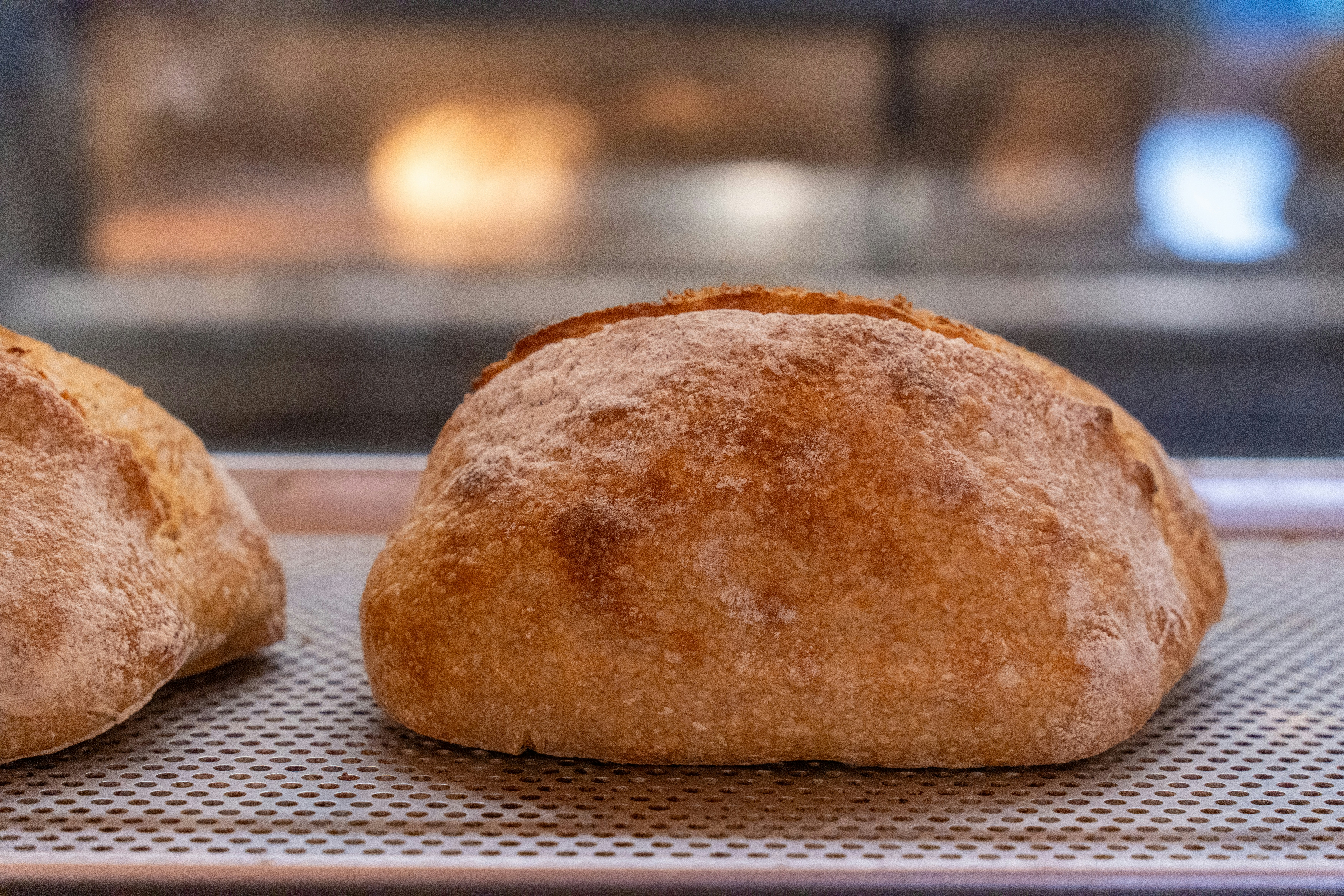 Freshly baked artisan bread on a cooling rack.