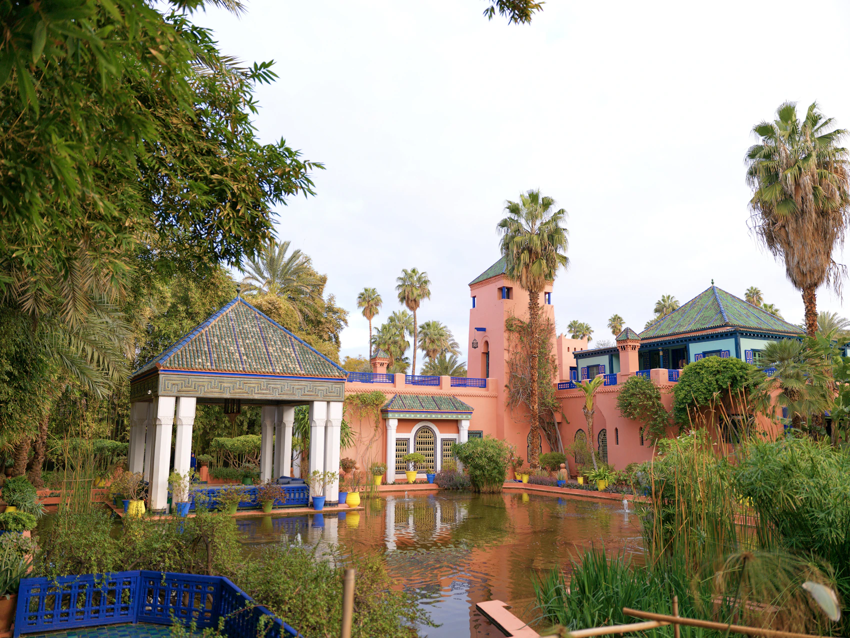 Palm trees, blue architecture and a reflecting pool in Jardin Majorelle