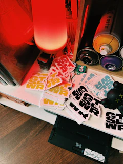 Sticker sheets and spray paint cans on shelf