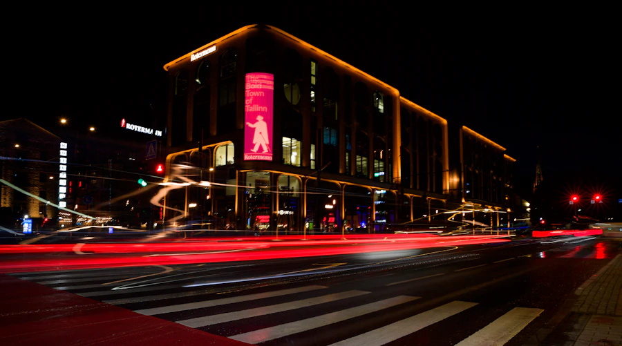 Long-exposure light trails on a wet city street at night