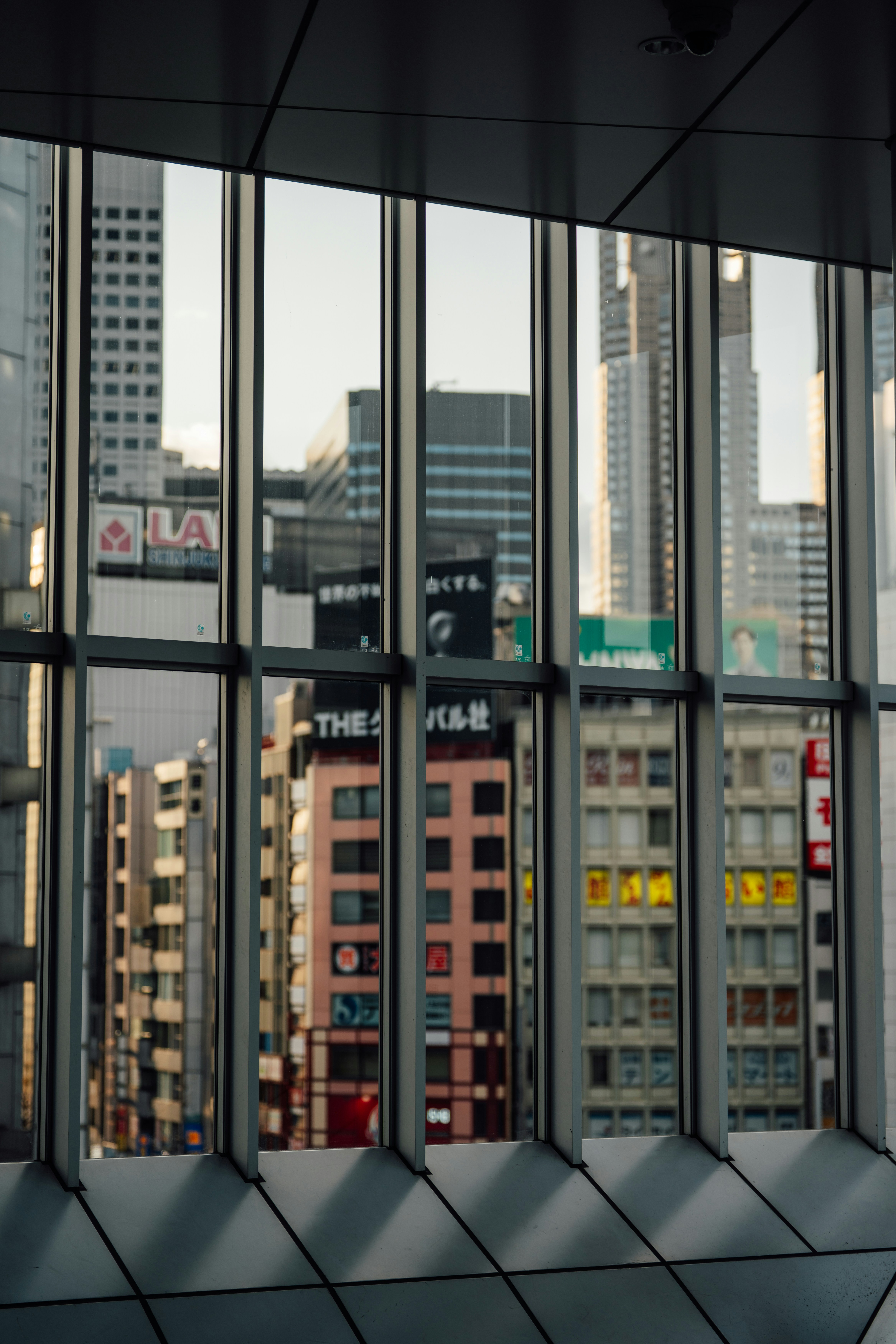 Modern cityscape viewed through a glass window