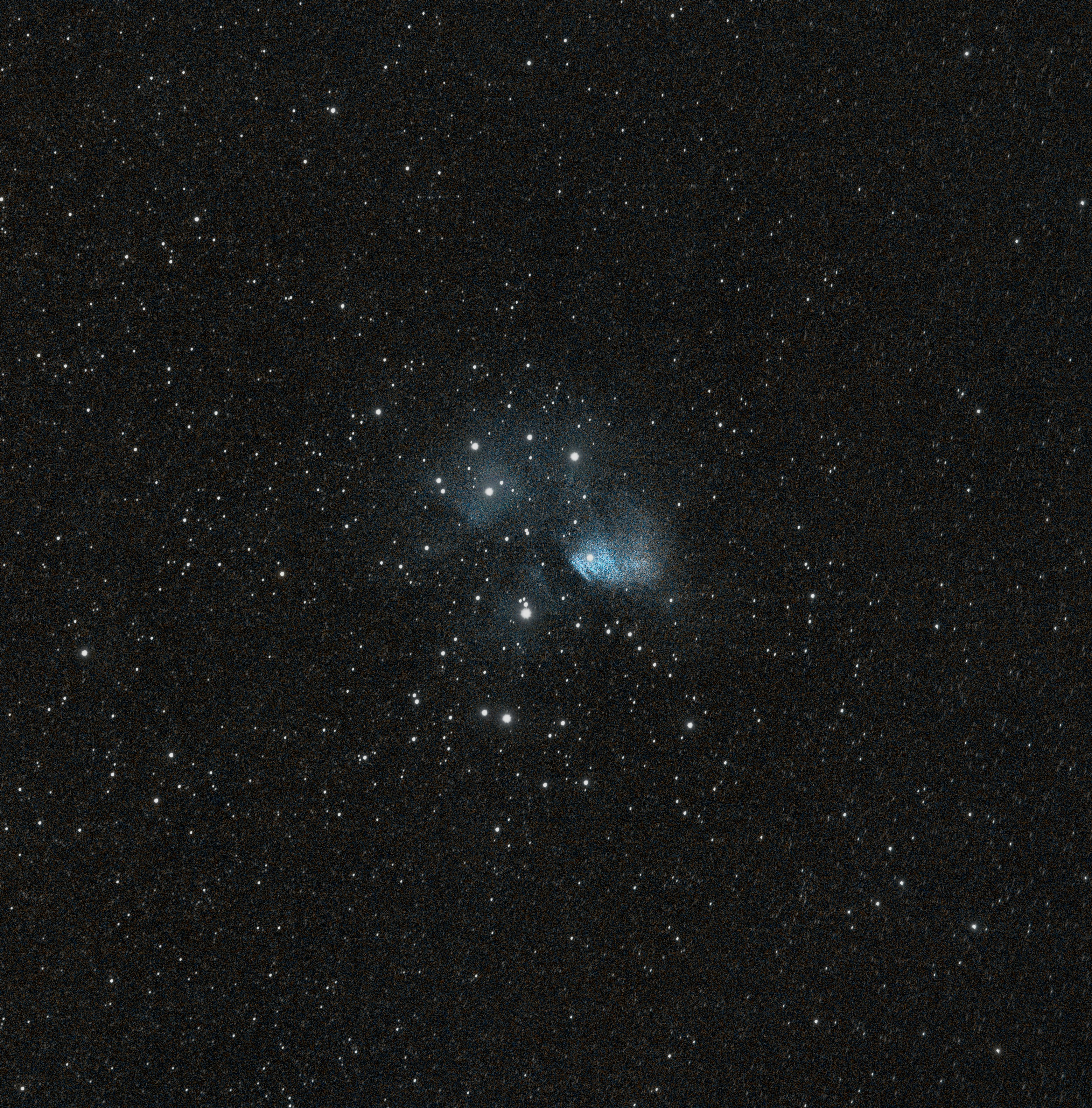 A colorful nebula glows in a star-filled night sky
