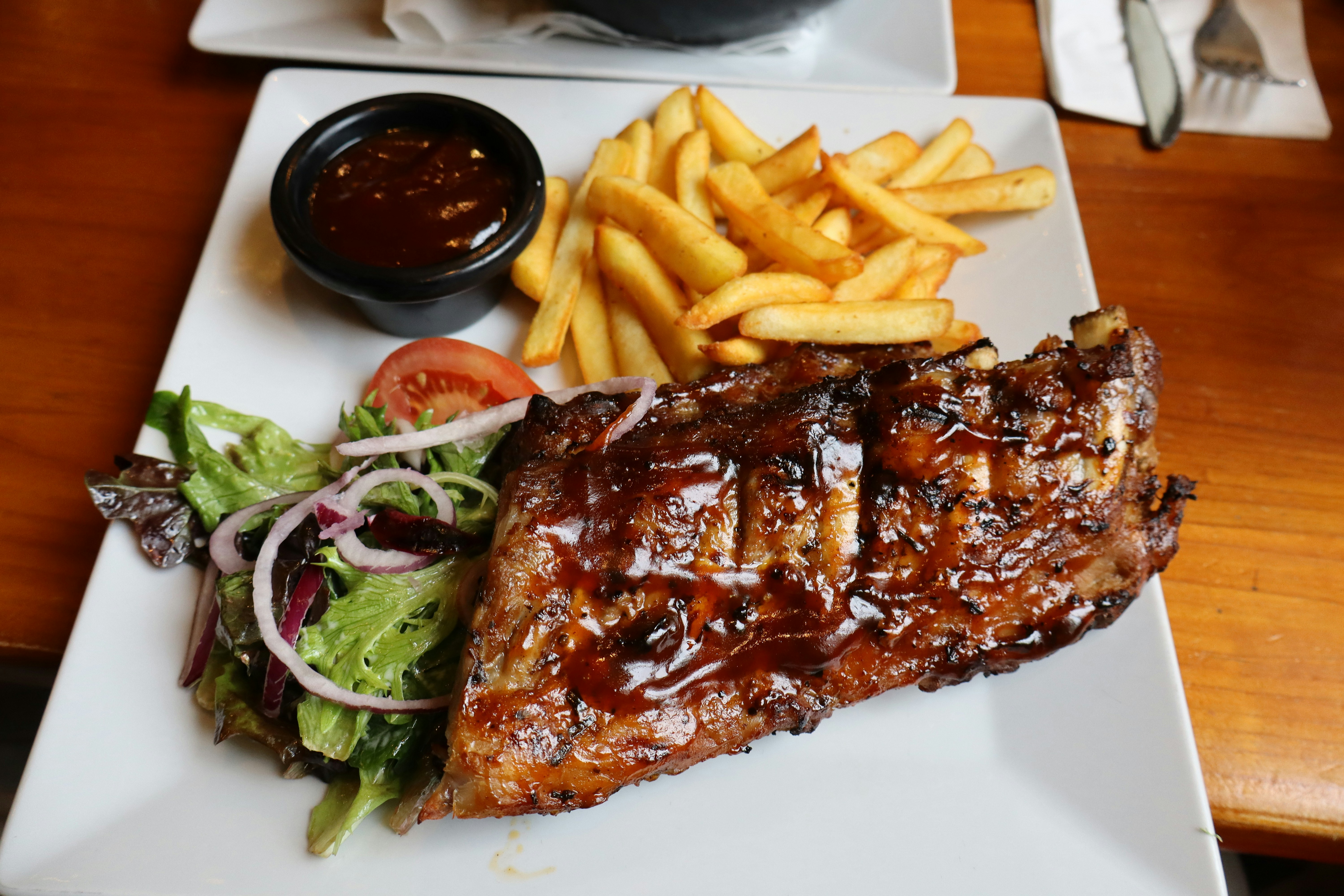 Barbecued ribs with french fries and salad