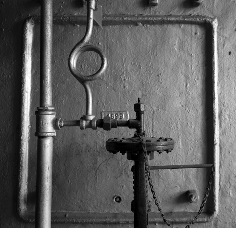 Industrial pipes and valve on a textured wall