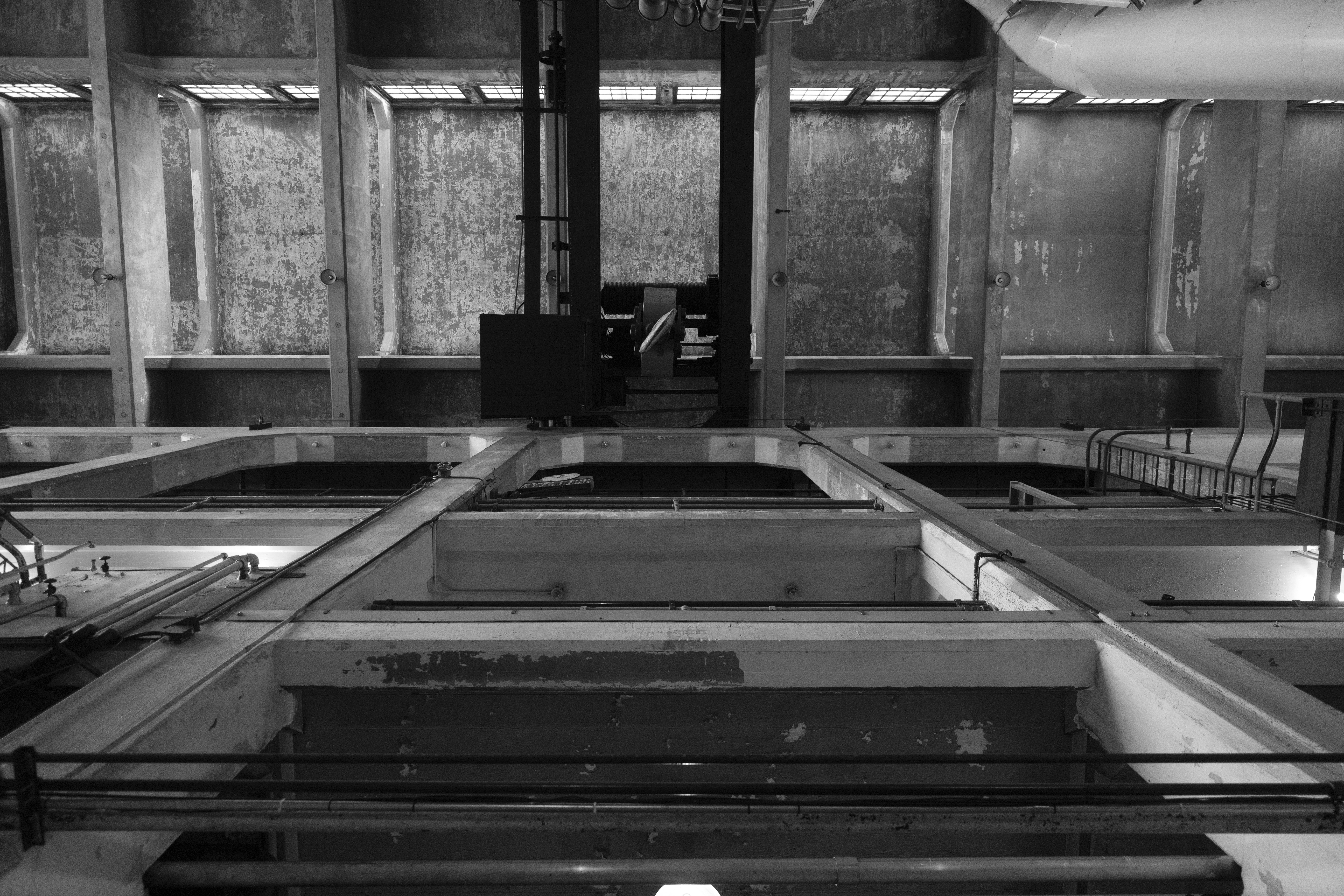 Looking up at concrete brutalist architecture with open windows.